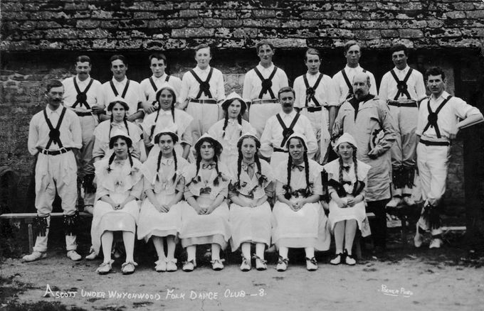 A vintage postcard shows women of the Ascott-under-Wychwood Folk Dance Club fraternising with the morris. Women dancers appeared at displays before the first women's sides were formed.